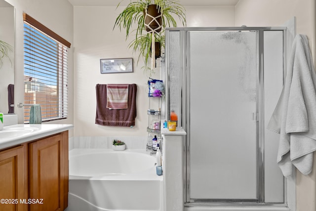 full bath with vanity, a bath, and a shower stall