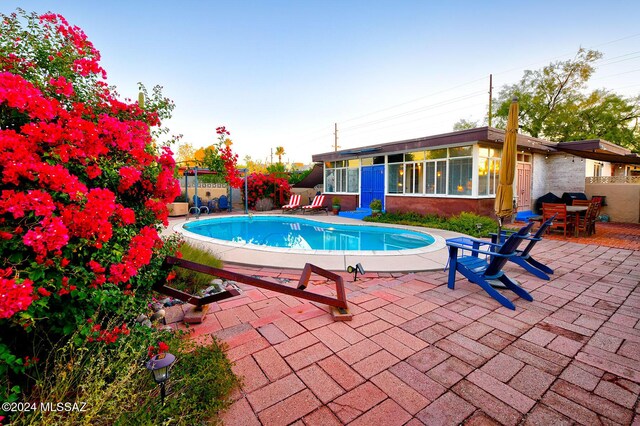 340 S Country Club Rd, Tucson, AZ 85716 - view of swimming pool with fence, a sunroom, a patio, and a fenced in pool