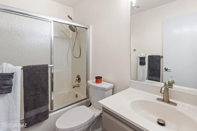 full bath featuring combined bath / shower with glass door, visible vents, toilet, and vanity