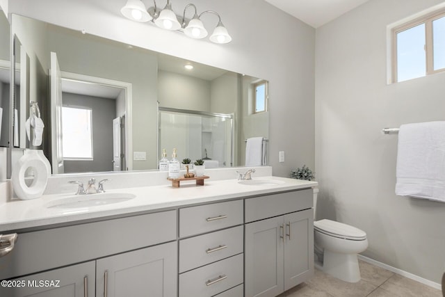 bathroom with plenty of natural light, a sink, and toilet