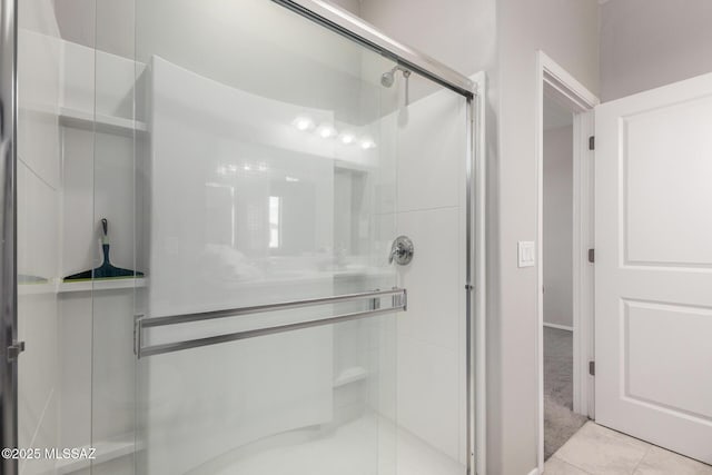 bathroom with tile patterned floors and a shower stall