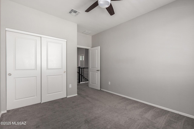 unfurnished bedroom with a closet, a ceiling fan, visible vents, carpet floors, and baseboards