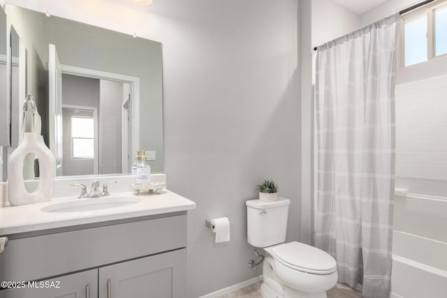 bathroom featuring toilet, shower / bath combo, vanity, and baseboards