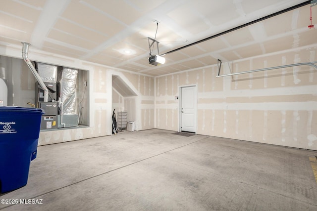 garage with a garage door opener and heating unit