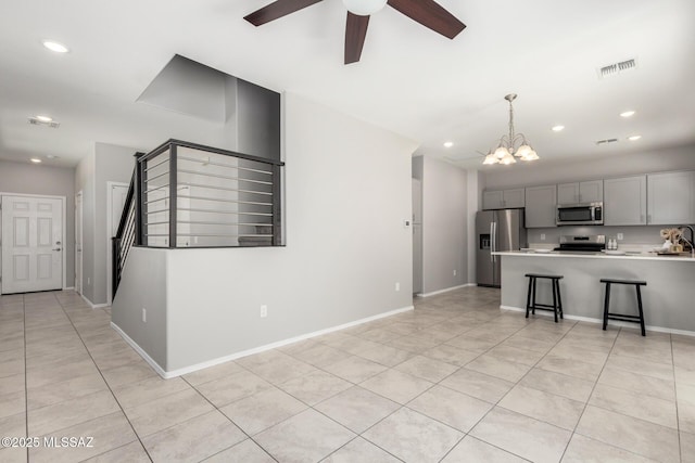 kitchen featuring visible vents, light tile patterned floors, light countertops, appliances with stainless steel finishes, and gray cabinets