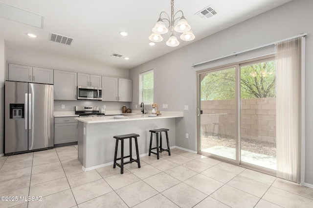 kitchen with light countertops, visible vents, appliances with stainless steel finishes, and gray cabinetry