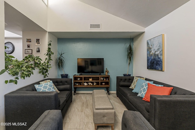 living room featuring visible vents and lofted ceiling