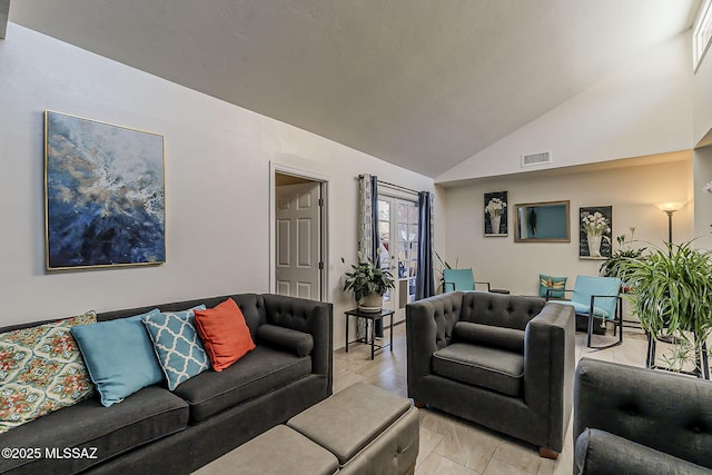 living room featuring lofted ceiling and visible vents