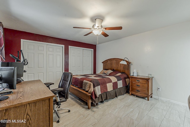 bedroom featuring baseboards, two closets, and ceiling fan