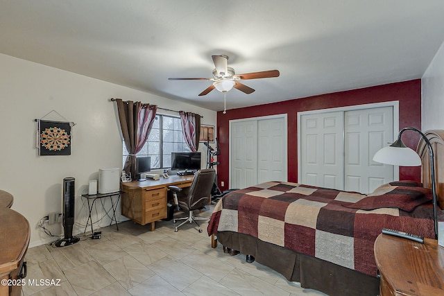 bedroom with multiple closets and ceiling fan