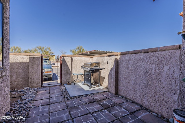 view of patio / terrace featuring a gate, fence, and grilling area