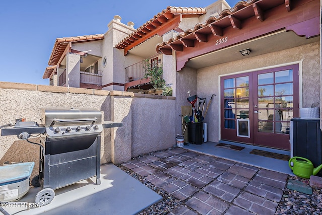 view of patio featuring a grill, fence, and french doors