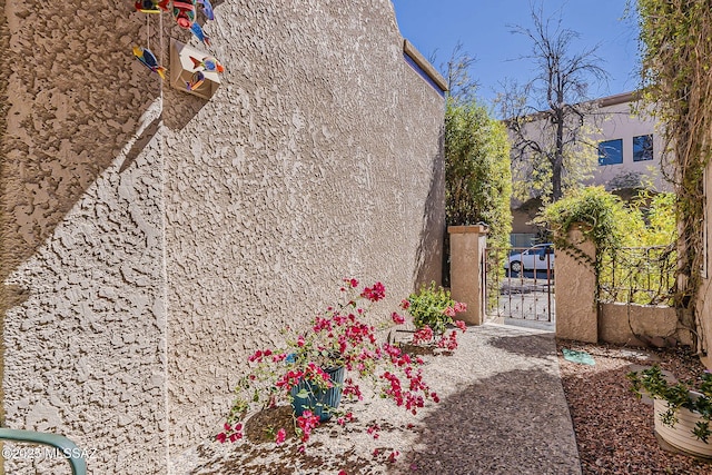 view of property exterior featuring a gate and stucco siding