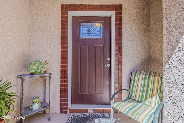 view of exterior entry with stucco siding