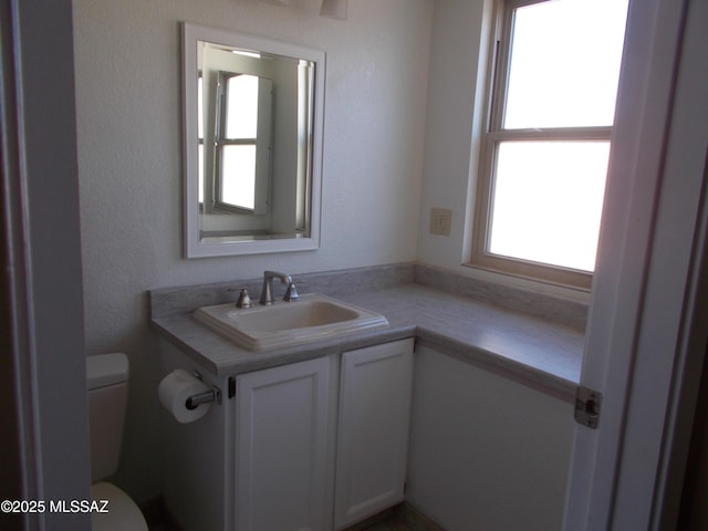 half bathroom featuring toilet and vanity