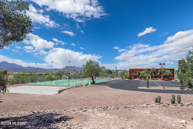 exterior space with fence, community basketball court, and a mountain view