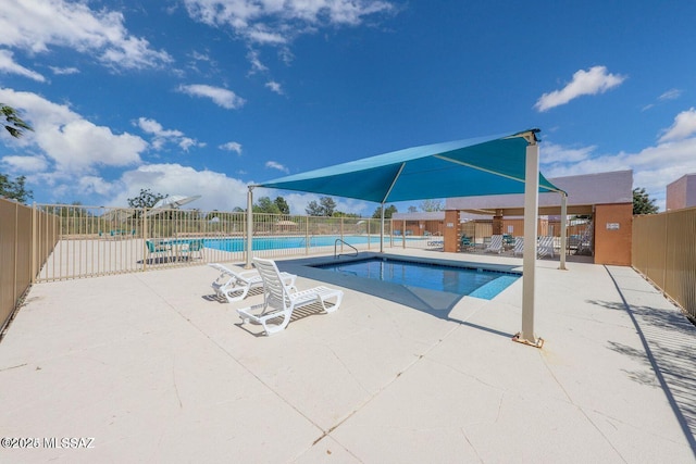 pool featuring a patio area and fence