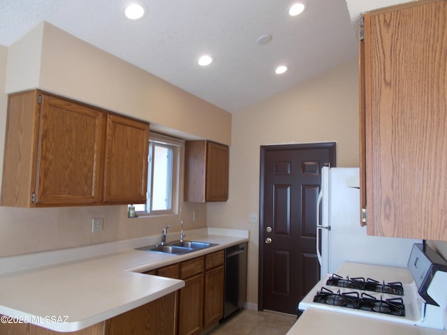 kitchen featuring brown cabinets, dishwashing machine, range with gas stovetop, and a sink