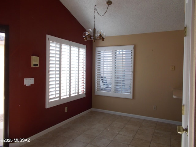 unfurnished dining area with lofted ceiling, a notable chandelier, a textured ceiling, and light tile patterned flooring