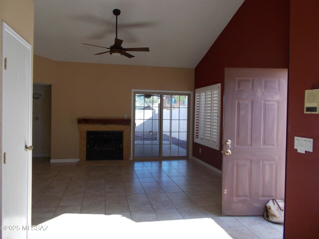 unfurnished living room featuring light tile patterned flooring, baseboards, high vaulted ceiling, a ceiling fan, and a fireplace