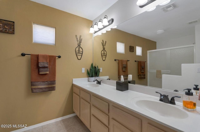 bathroom with visible vents, a sink, and tile patterned floors