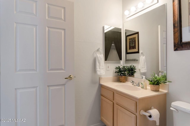 half bathroom featuring toilet and vanity