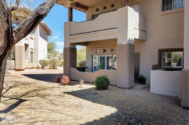 view of side of home featuring stucco siding