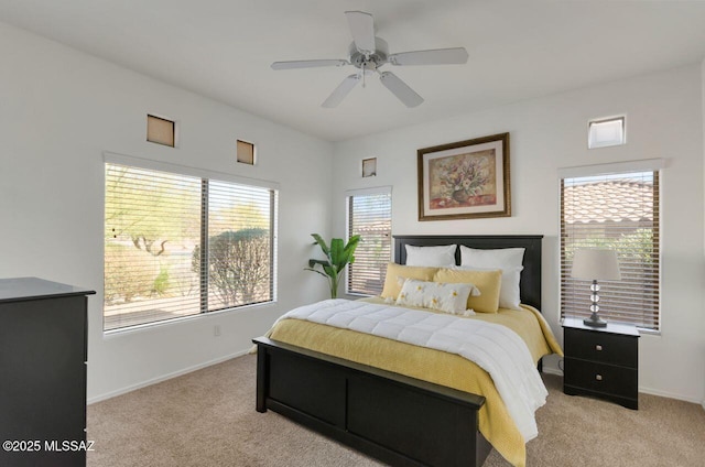 bedroom featuring light carpet, baseboards, and ceiling fan