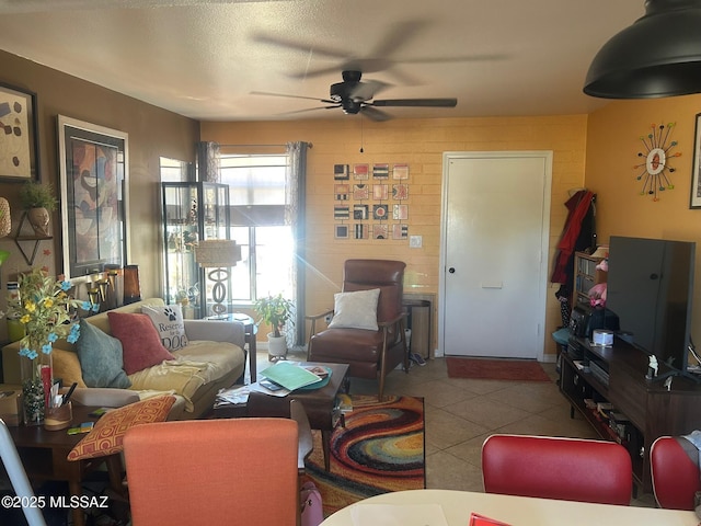 living room featuring tile patterned flooring and ceiling fan