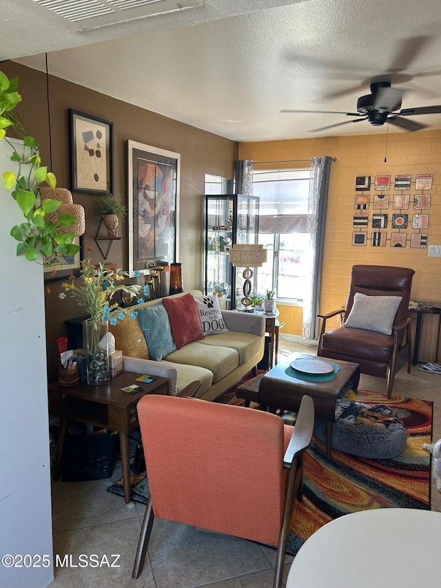 living room featuring a textured ceiling and ceiling fan