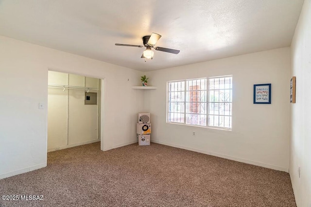 unfurnished bedroom featuring a closet, ceiling fan, baseboards, and light carpet
