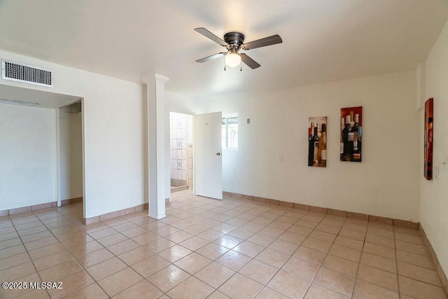 spare room with baseboards, visible vents, ceiling fan, and light tile patterned floors