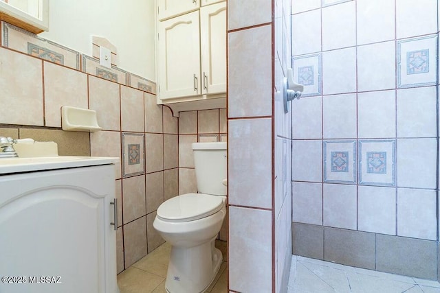 bathroom featuring tile walls, toilet, tile patterned flooring, and vanity