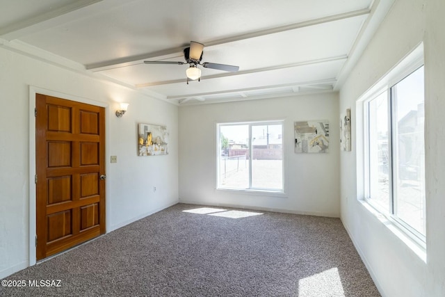 empty room featuring a ceiling fan, carpet, and beamed ceiling