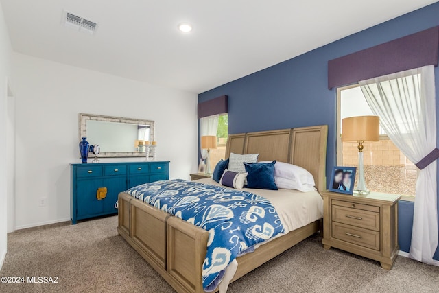 bedroom featuring light carpet, baseboards, and visible vents