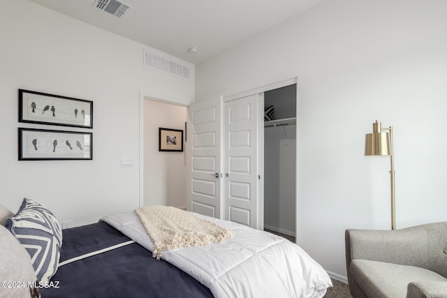 carpeted bedroom with a closet and visible vents