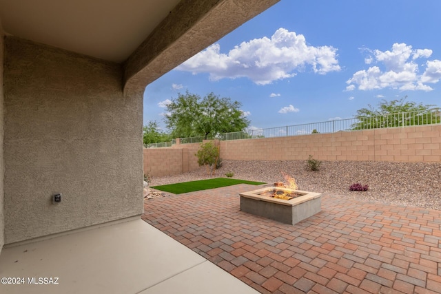 view of patio featuring a fenced backyard and an outdoor fire pit