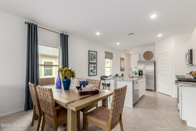 dining room with light tile patterned flooring, baseboards, visible vents, and recessed lighting