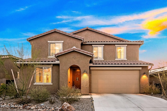 10150 S Rolling Water Dr, Vail, AZ 85641 - mediterranean / spanish-style home featuring driveway, stucco siding, a tiled roof, and an attached garage