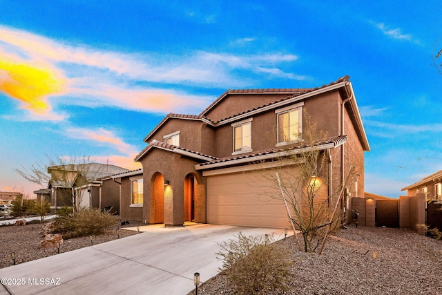 10150 S Rolling Water Dr, Vail, AZ 85641 - mediterranean / spanish house featuring fence, an attached garage, a tile roof, concrete driveway, and stucco siding