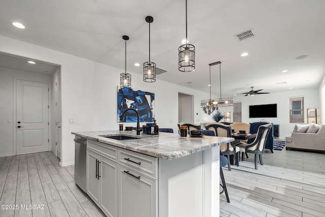 10150 S Rolling Water Dr, Vail, AZ 85641 - kitchen featuring a sink, open floor plan, visible vents, ceiling fan, and dishwasher