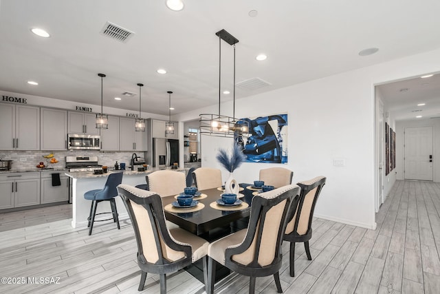 10150 S Rolling Water Dr, Vail, AZ 85641 - dining space featuring baseboards, recessed lighting, light wood finished floors, and visible vents