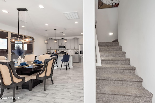 10150 S Rolling Water Dr, Vail, AZ 85641 - dining area with recessed lighting, visible vents, and stairs