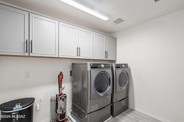 10150 S Rolling Water Dr, Vail, AZ 85641 - washroom featuring cabinet space, visible vents, separate washer and dryer, light wood finished floors, and baseboards