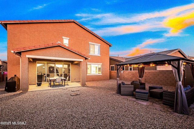 10150 S Rolling Water Dr, Vail, AZ 85641 - back of property with stucco siding, a tile roof, a gazebo, a patio area, and an outdoor living space