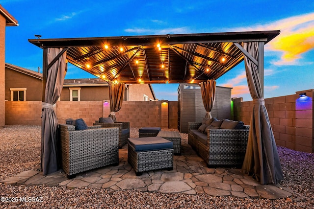 10150 S Rolling Water Dr, Vail, AZ 85641 - patio terrace at dusk featuring a fenced backyard and an outdoor living space