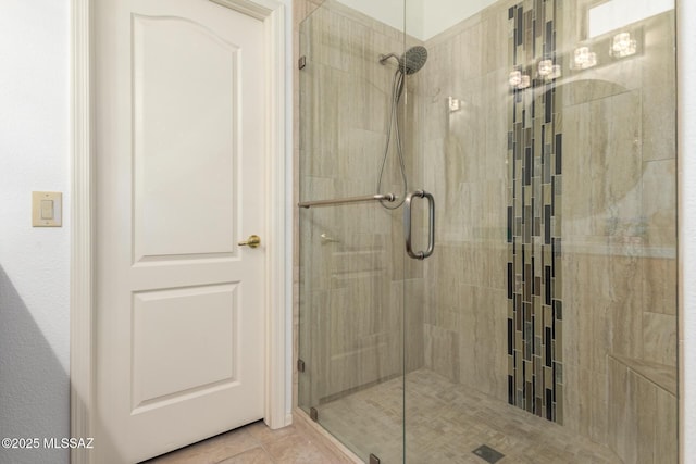 full bathroom featuring a stall shower and tile patterned flooring