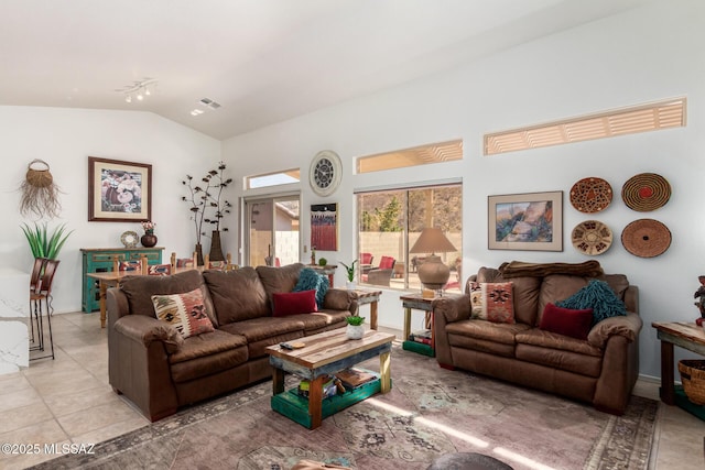 living room with light tile patterned floors, vaulted ceiling, and visible vents