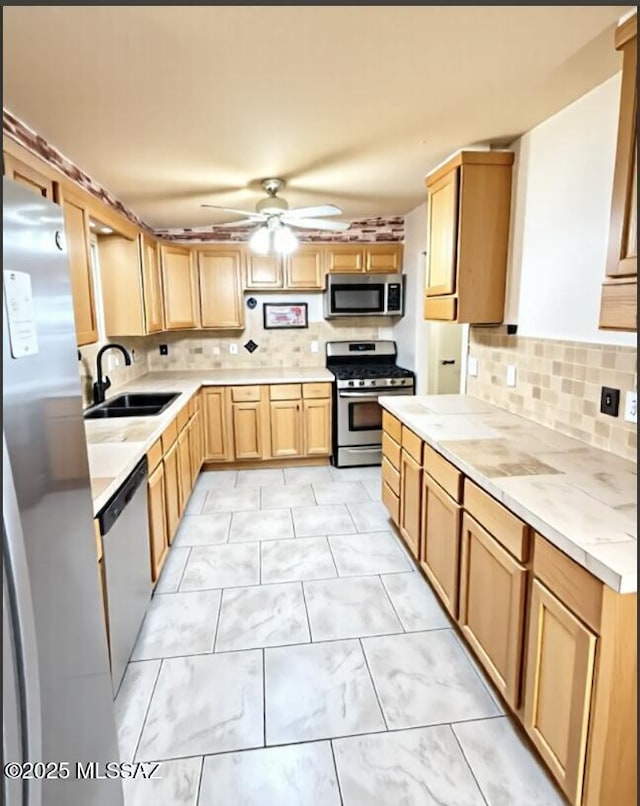 6902 E Calle Neptuno, Tucson, AZ 85710 - kitchen featuring appliances with stainless steel finishes, a ceiling fan, backsplash, and light countertops