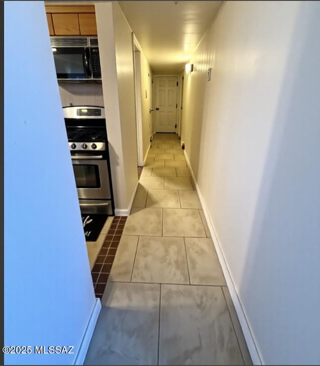 6902 E Calle Neptuno, Tucson, AZ 85710 - corridor with tile patterned floors and baseboards